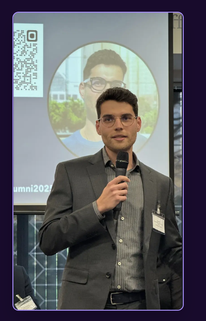 Anas Riad speaking at a conference about AI automation